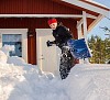 Woman shoveling snow in front of the house