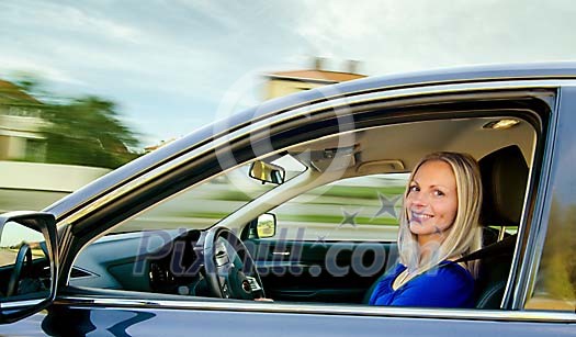 Blonde girl driving a car