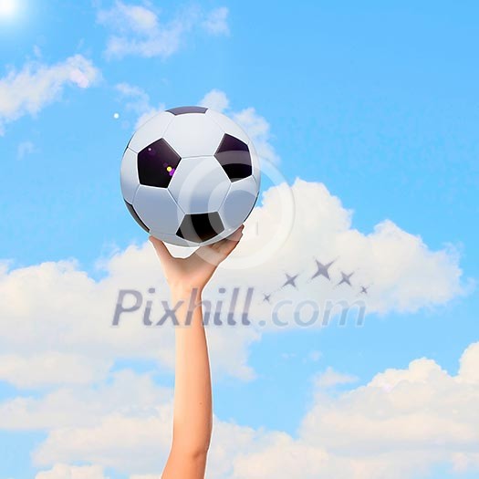 Close-up image of hand holding soccer ball