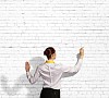 Businesswoman standing with back drawing on blank wall