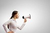 Image of young businesswoman screaming in megaphone