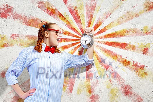 Young woman with an old-fashioned alarm clock Young woman with an old-fashioned alarm clock