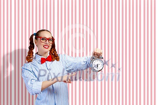 Young woman with an old-fashioned alarm clock