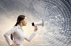 Image of young businesswoman screaming in megaphone