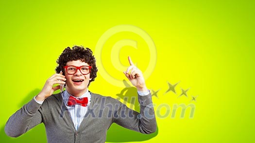 Young man talking over his mobile phone and having an idea Young man talking over his mobile phone and having an idea