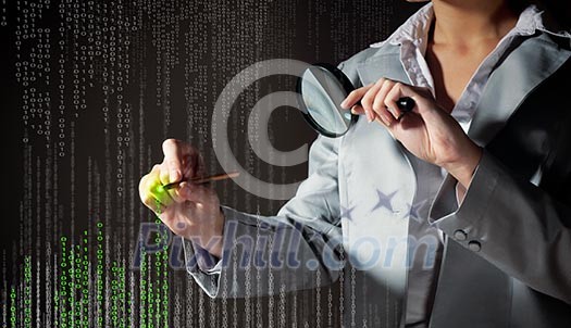 Businesswoman with magnifier glass examining binary code