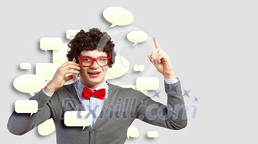 Young man talking over his mobile phone and having an idea Young man talking over his mobile phone and having an idea
