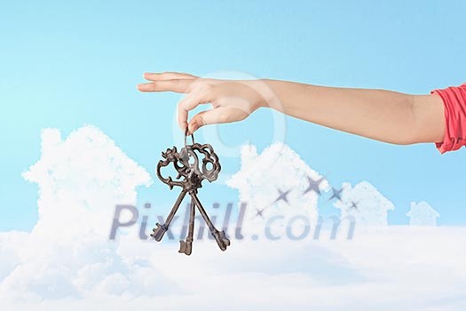 Close up image of human hand holding keys