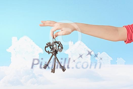 Close up image of human hand holding keys Close up image of human hand holding keys