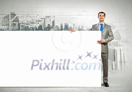 Businessman with blank banner standing against urban scenic. Place for text Businessman with blank banner standing against urban scenic. Place for text