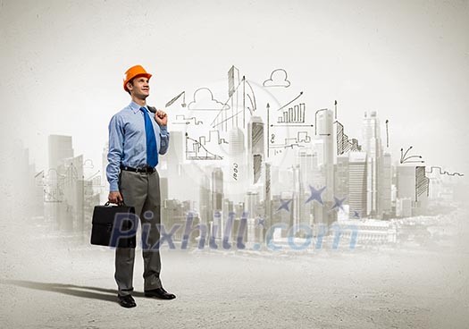 Image of man engineer in helmet with drafts. Construction concept Image of man engineer in helmet with drafts. Construction concept