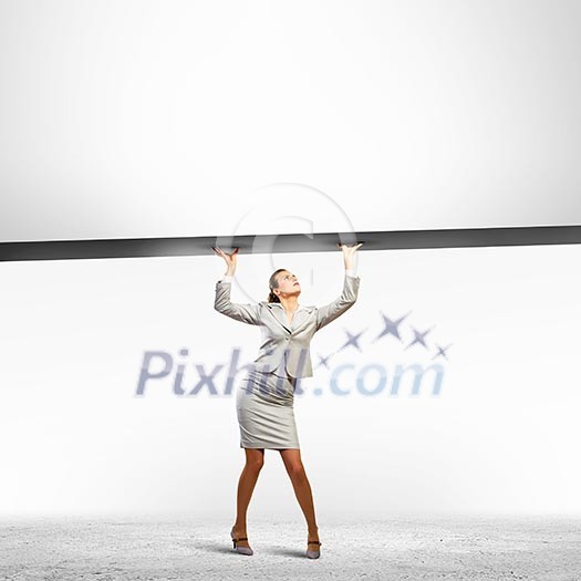 Businesswoman holding blank banner above head. Place for text Businesswoman holding blank banner above head. Place for text