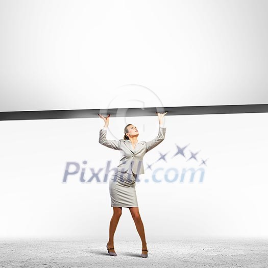 Businesswoman holding blank banner above head. Place for text