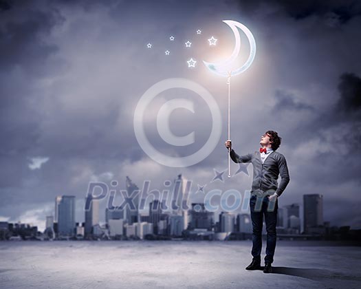 Young man and the moon symbol against polluted and ruined landscape Young man and the moon symbol against polluted and ruined landscape