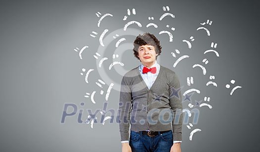 Image of young upset man in red tie crying