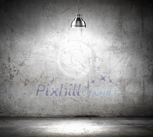 Stone blank wall illuminated with hanging above lamp. Place for text