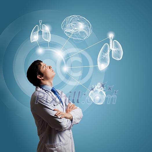 Young concentrated male doctor with arms crossed against digital background