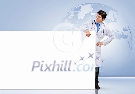 Young male doctor with blank banner. Place for text Young male doctor with blank banner. Place for text