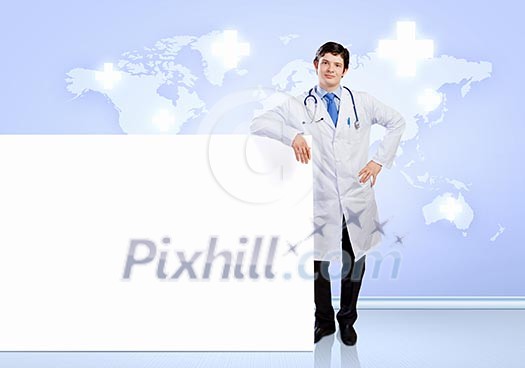 Young male doctor with blank banner. Place for text Young male doctor with blank banner. Place for text