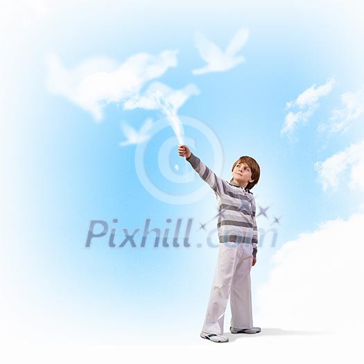 Image of little cute boy catching clouds in sky