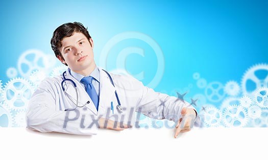 Young male doctor with blank banner. Place for text Young male doctor with blank banner. Place for text