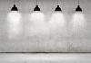 Blank cement wall with place for text illuminated by lamps above