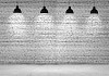 Blank brick wall with place for text illuminated by lamps above