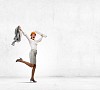 Young woman engineer in helmet jumping joyfully