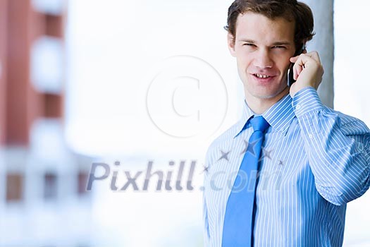Image of handsome businessman speaking on mobile phone