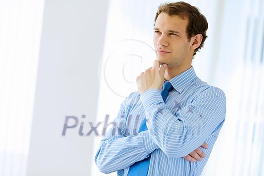 Image of young handsome confident businessman in suit