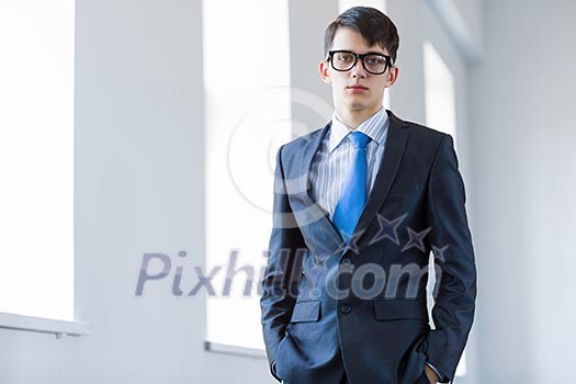 Image of handsome confident businessman in glasses