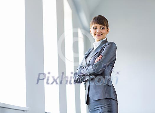 Image of young attractive businesswoman in business suit smiling Image of young attractive businesswoman in business suit smiling