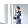 Image of young attractive businesswoman in business suit smiling