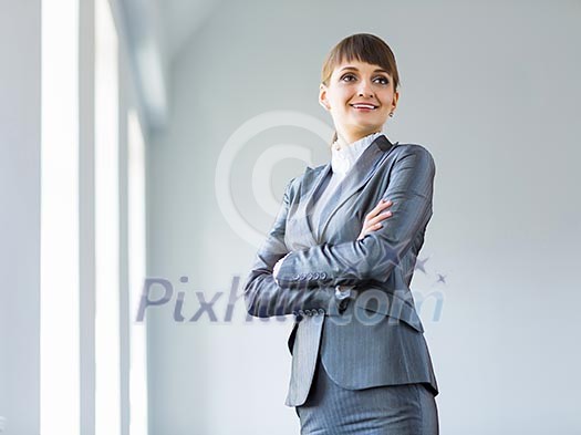 Image of young attractive businesswoman in business suit smiling