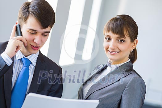 Young happy businessman and businesswoman people discussing project