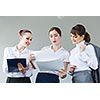 Image of attractive businesswomen holding folders and discussing