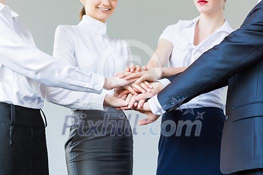 Business people making pile of hands. Partnership concept Business people making pile of hands. Partnership concept