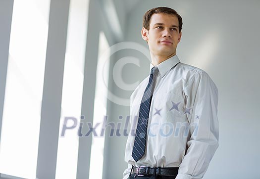 Handsome smiling confident businessman looking into distance