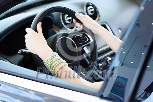 Close up of woman hands driving a car