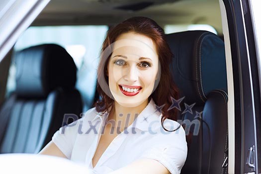 Attractive young woman sitting in car in car center Attractive young woman sitting in car in car center