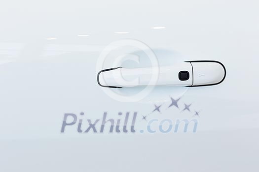 Close up image of white car door handle Close up image of white car door handle