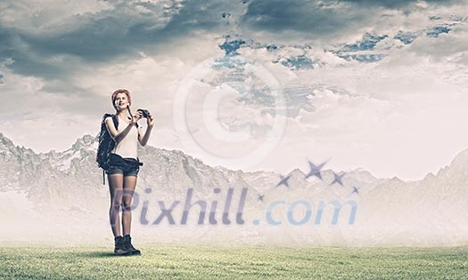 Pretty young woman tourist standing on top of mountain Pretty young woman tourist standing on top of mountain