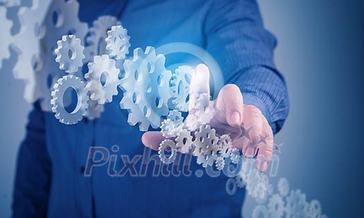 Image of businessman touching gear elements. Mechanism concept Image of businessman touching gear elements. Mechanism concept