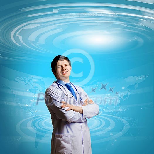 Image of young thoughtful doctor looking at media screen Image of young thoughtful doctor looking at media screen