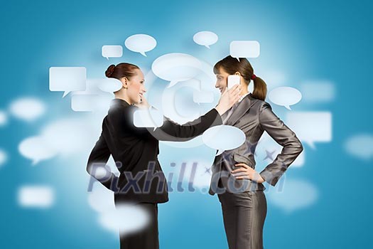 Two businesswomen talking on mobile phone. Cooperation concept