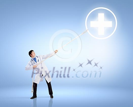Image of male doctor pulling health sign with rope Image of male doctor pulling health sign with rope