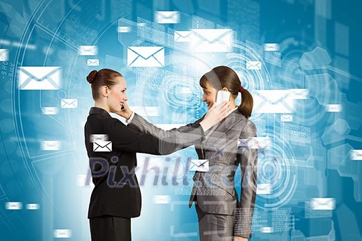 Two businesswomen talking on mobile phone. Cooperation concept Two businesswomen talking on mobile phone. Cooperation concept