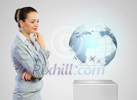 Image of thoughtful businesswoman looking at globe Image of thoughtful businesswoman looking at globe