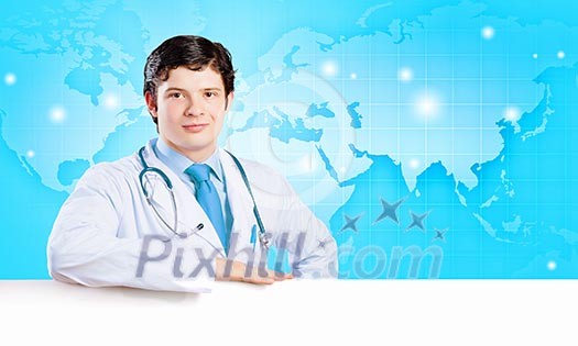 Image of handsome doctor holding white blank banner Image of handsome doctor holding white blank banner