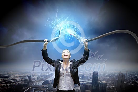 Image of businesswoman holding electrical cable above head Image of businesswoman holding electrical cable above head